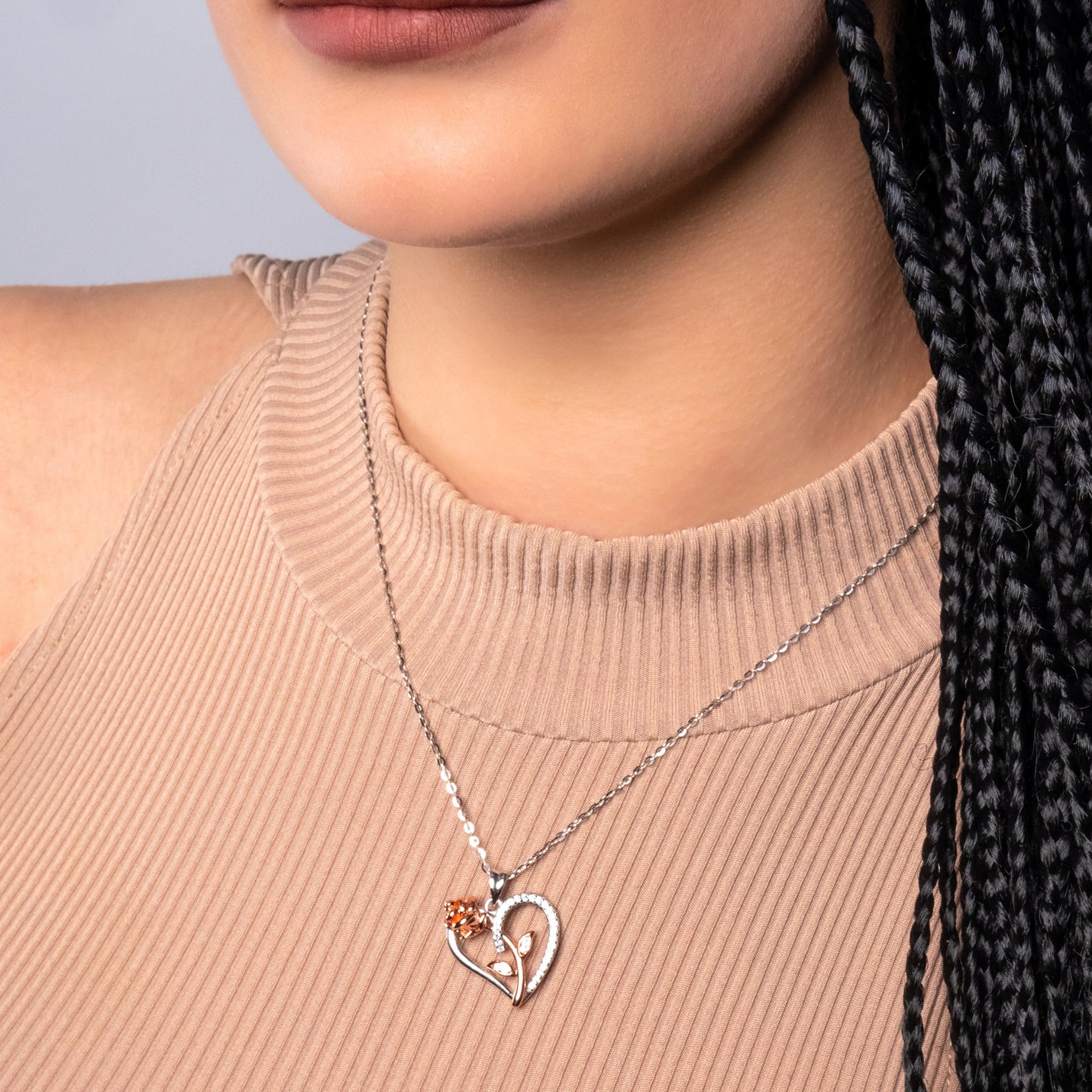 A model wearing 925 Sterling Silver Rose in the Heart Crystal Pendant with 925 Sterling Silver Flat Cable Necklace on her neck