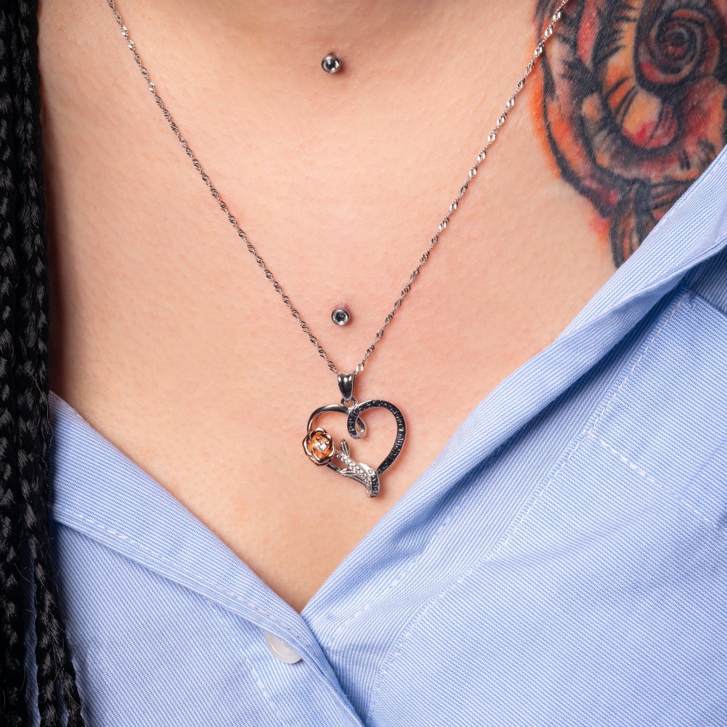 Model wearing Rose Heart Engraved Pendant. Zoomed-in.