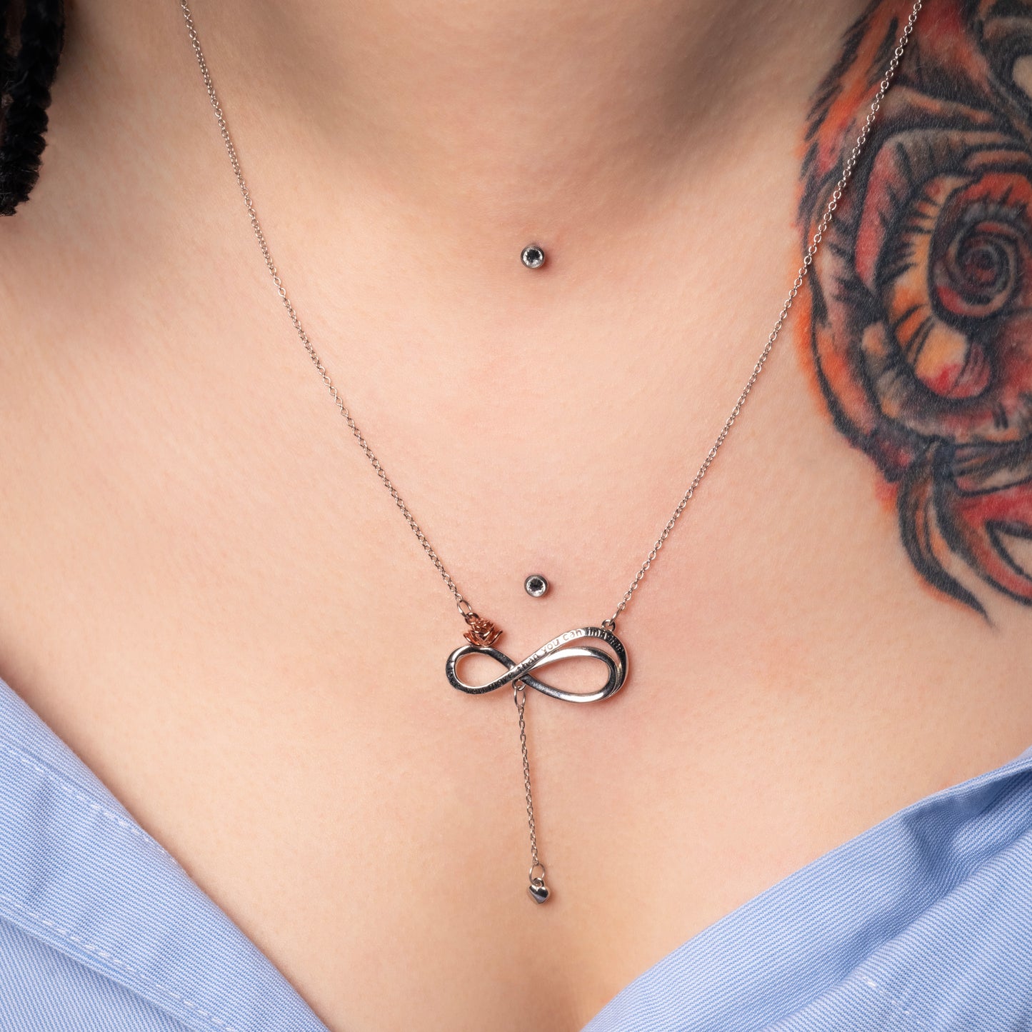 Model wearing Infinity Love Engraved Silver Necklace. Zoomed view.
