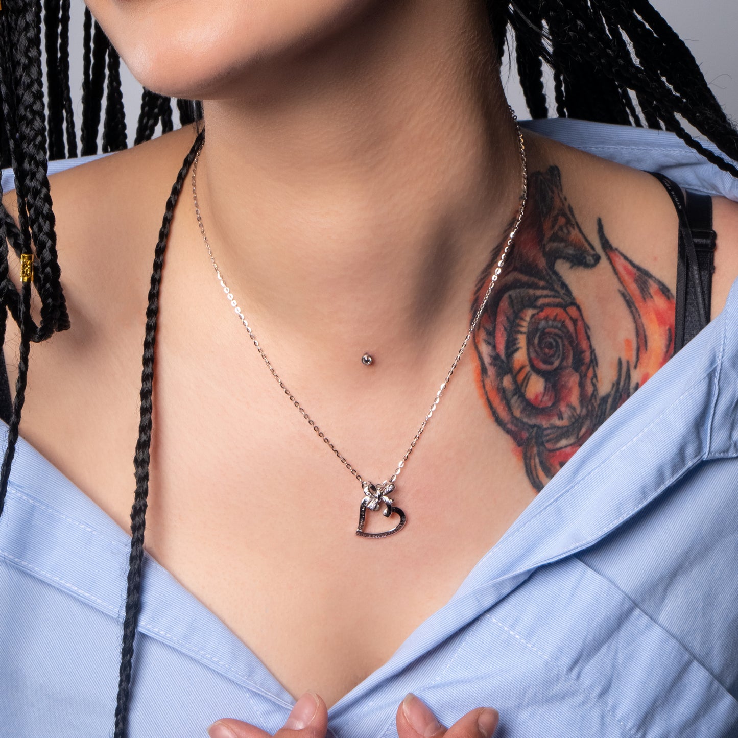 Model wearing Bow Heart Silver Pendant with Flat Cable necklace.