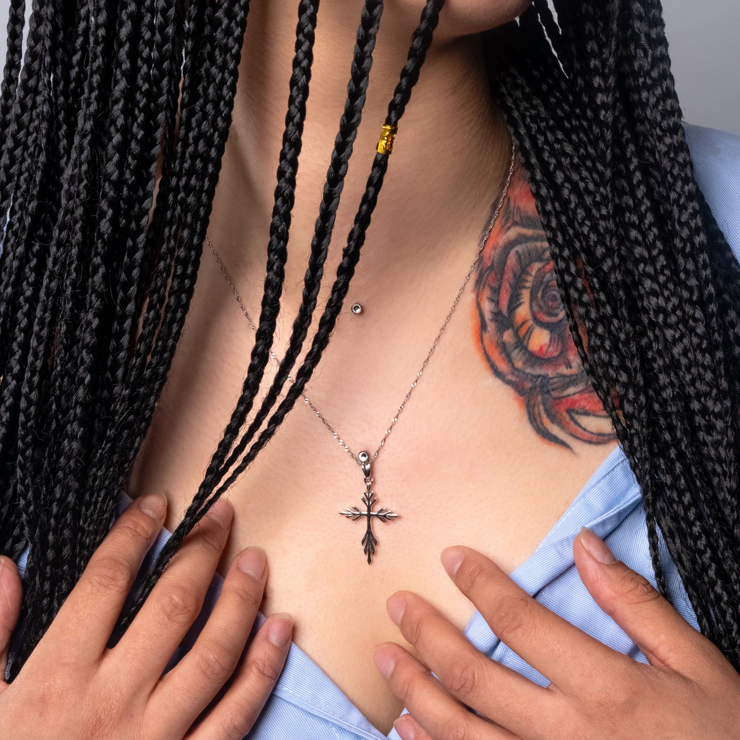 Model wearing Angel Cross Silver Pendant with Water Wave necklace.