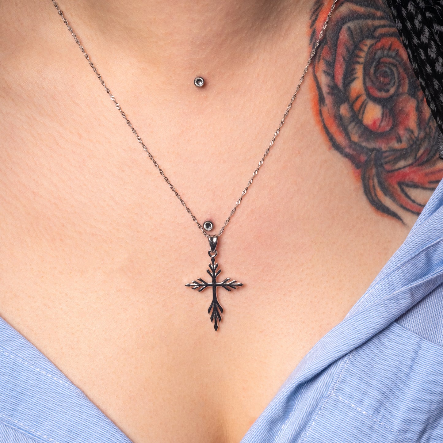 Model wearing Angel Cross Silver Pendant with Water Wave necklace. Zoomed-in view.