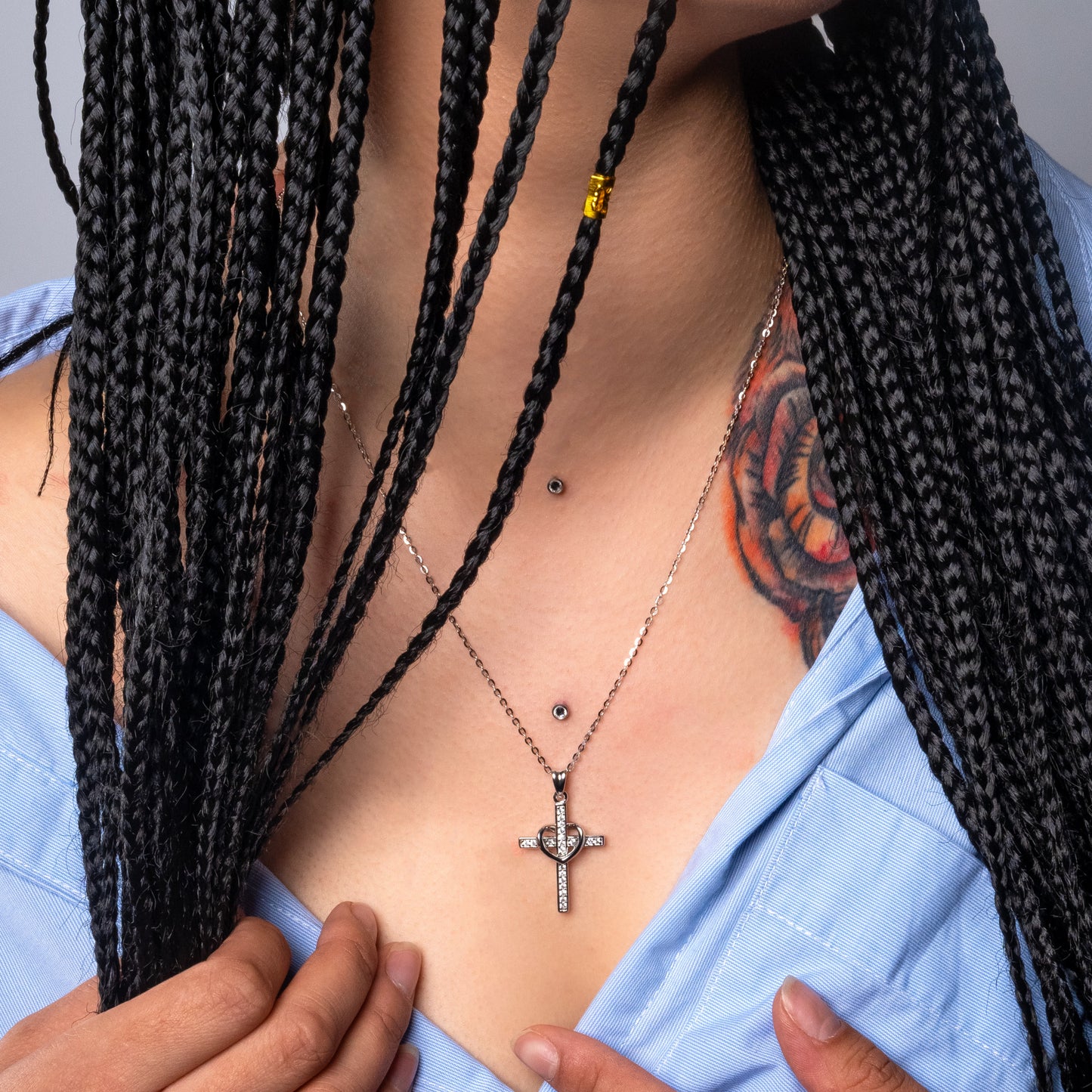 Model wearing Cross and Heart Silver Pendant with Flat cable necklace.