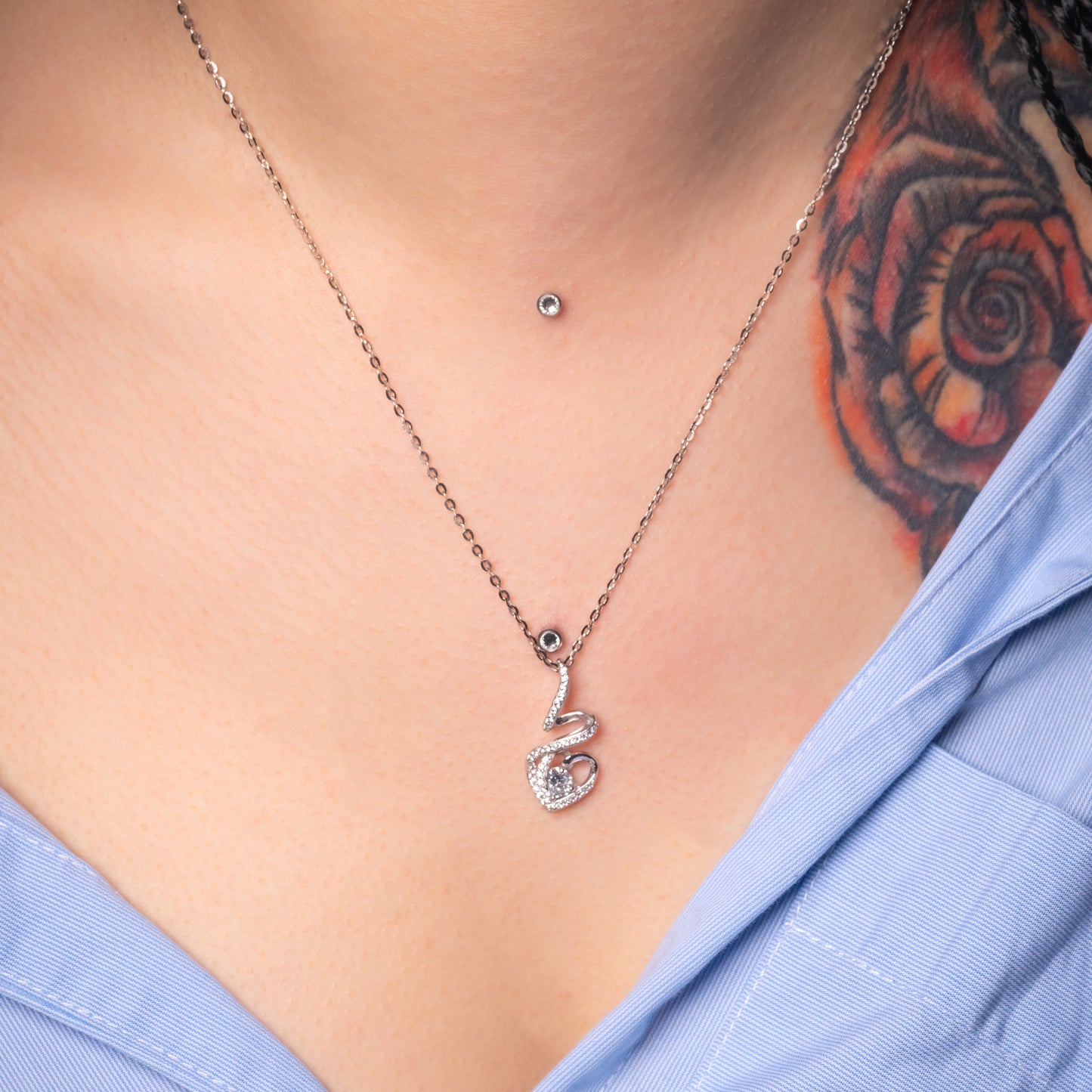 Model wearing Solitaire Heart Crystal Silver Pendant with Flat Cable necklace. Zoomed-in view.