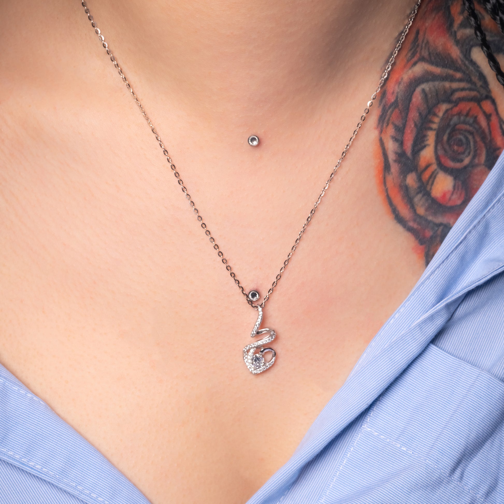 Model wearing Solitaire Heart Crystal Silver Pendant with Flat Cable necklace. Zoomed-in view.