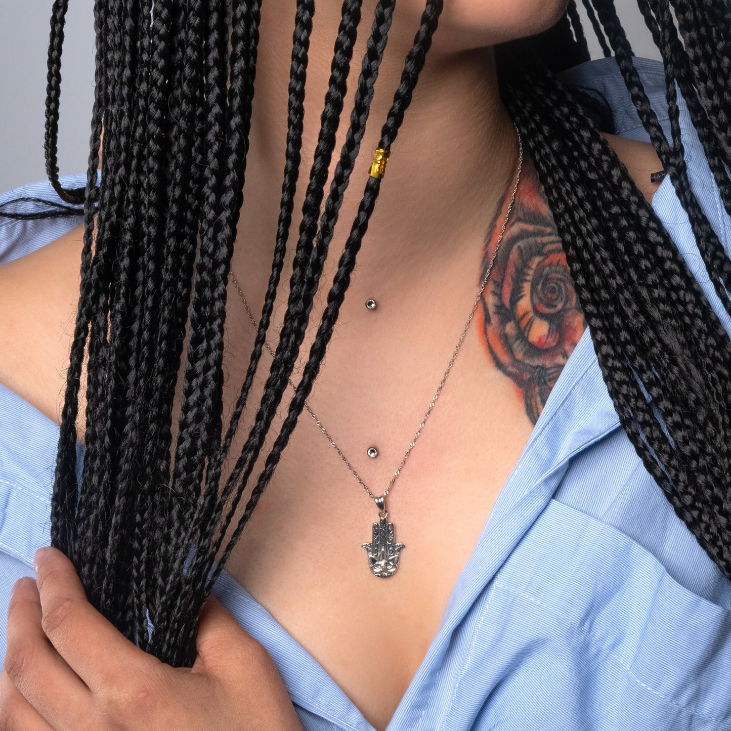 Model wearing Hamsa Hand Silver Pendant paired with Water Wave necklace.