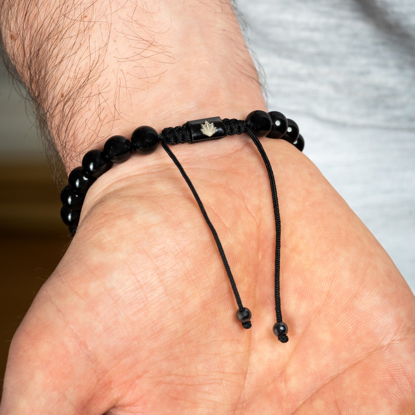 Model wearing Black Agate Skull bracelet in Black. Reverse side.