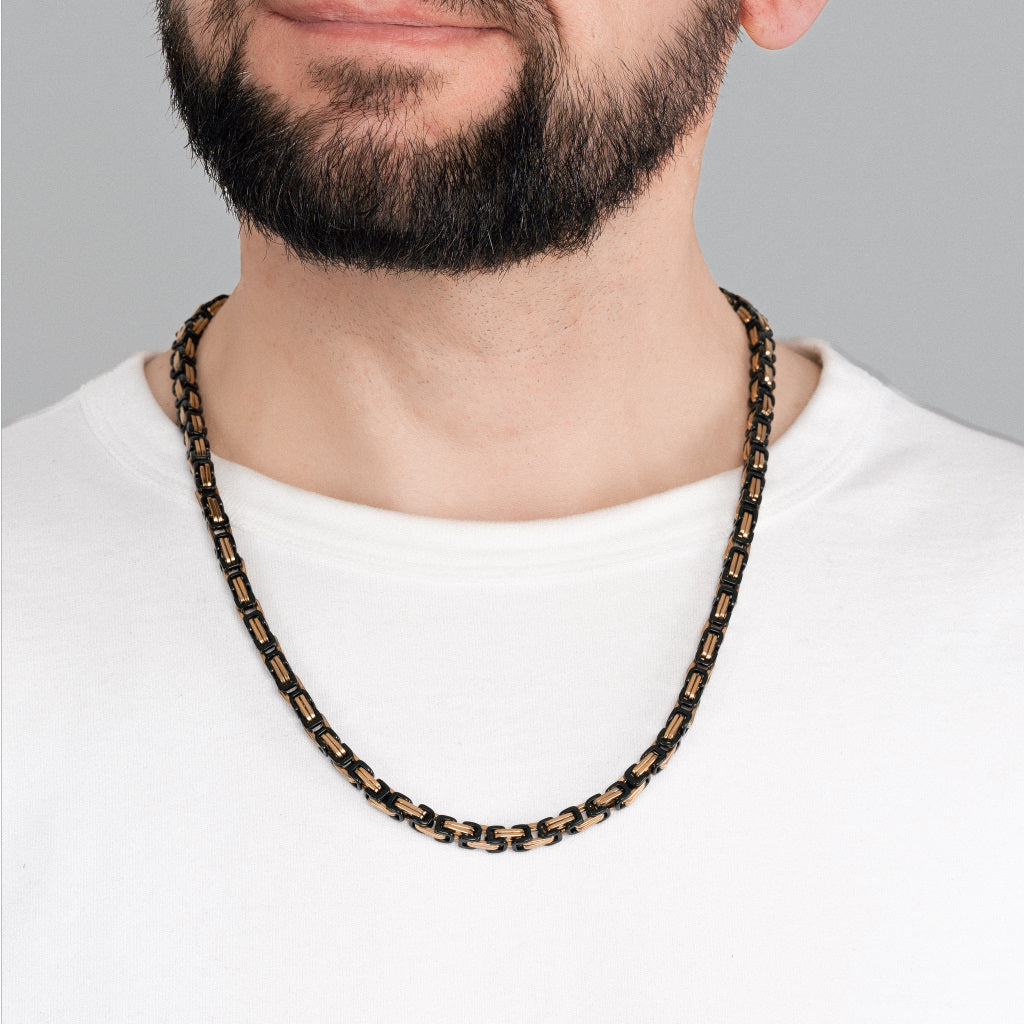 A bearded man in white t-shirt wearing 2 tone Gold Black Byzantine Box link Chain 5mm, 24 inches, luxury lifetime stainless steel men's jewellery