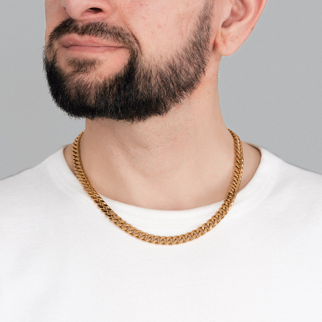 A bearded brutal man in white t-shirt wearing Gold Miami Cuban Chain 8 mm