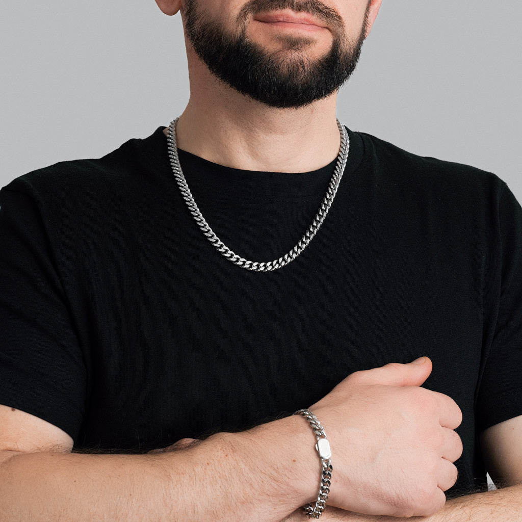 A bearded male model in black t-shirt wearing Silver Miami Cuban Chain 8 mm with a matching Silver Miami Cuban Bracelet 8mm.