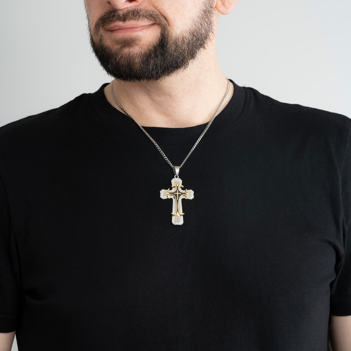 A male model in a black t-shirt wearing a Trinity Cross Pendant with a 3mm Silver Micro Cuban chain 22 inches.