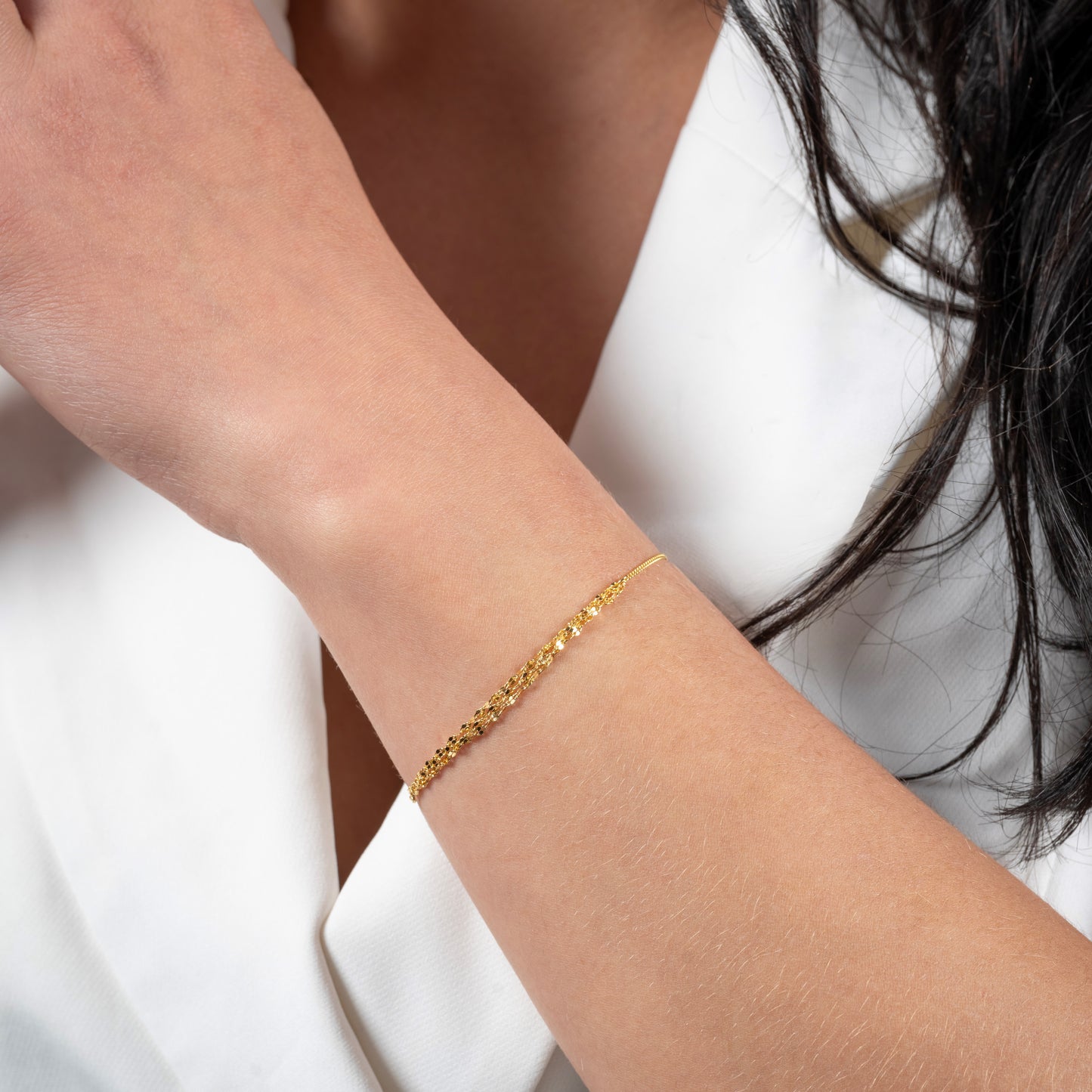 A model wearing Half Crumpled Gold Bracelet on her hand. Zoomed view.