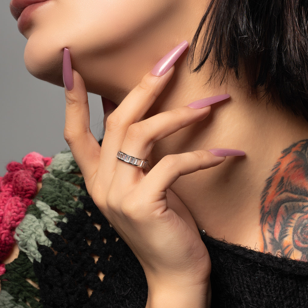A model wearing Cubic Zirconia Baguette cut 925 Sterling Silver Band Ring on her finger.