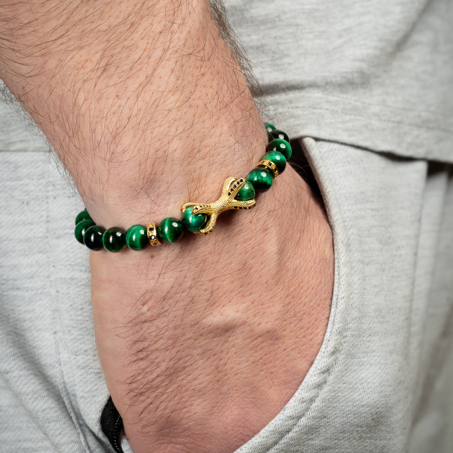 Model wearing Dragon Claw Green Tiger's Eye Bracelet on his wrist.