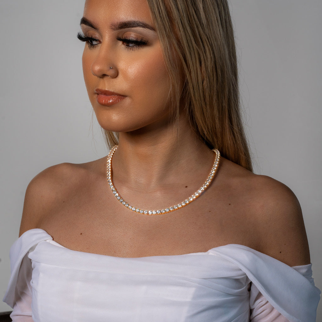 Female model in white dress wearing Cubic Zirconia 5mm Gold Tennis Necklace