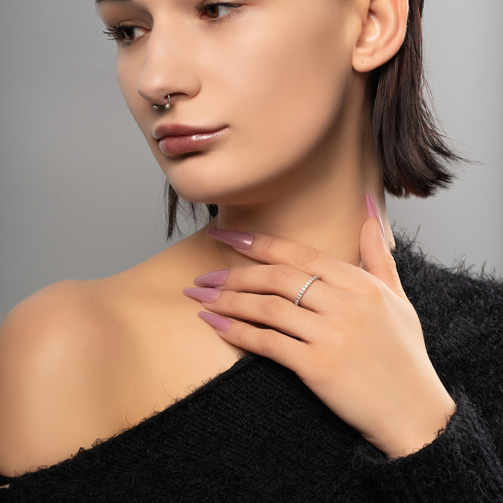 A female model wearing Tennis Eternity Cubic Zirconia 925 Sterling Silver band ring.