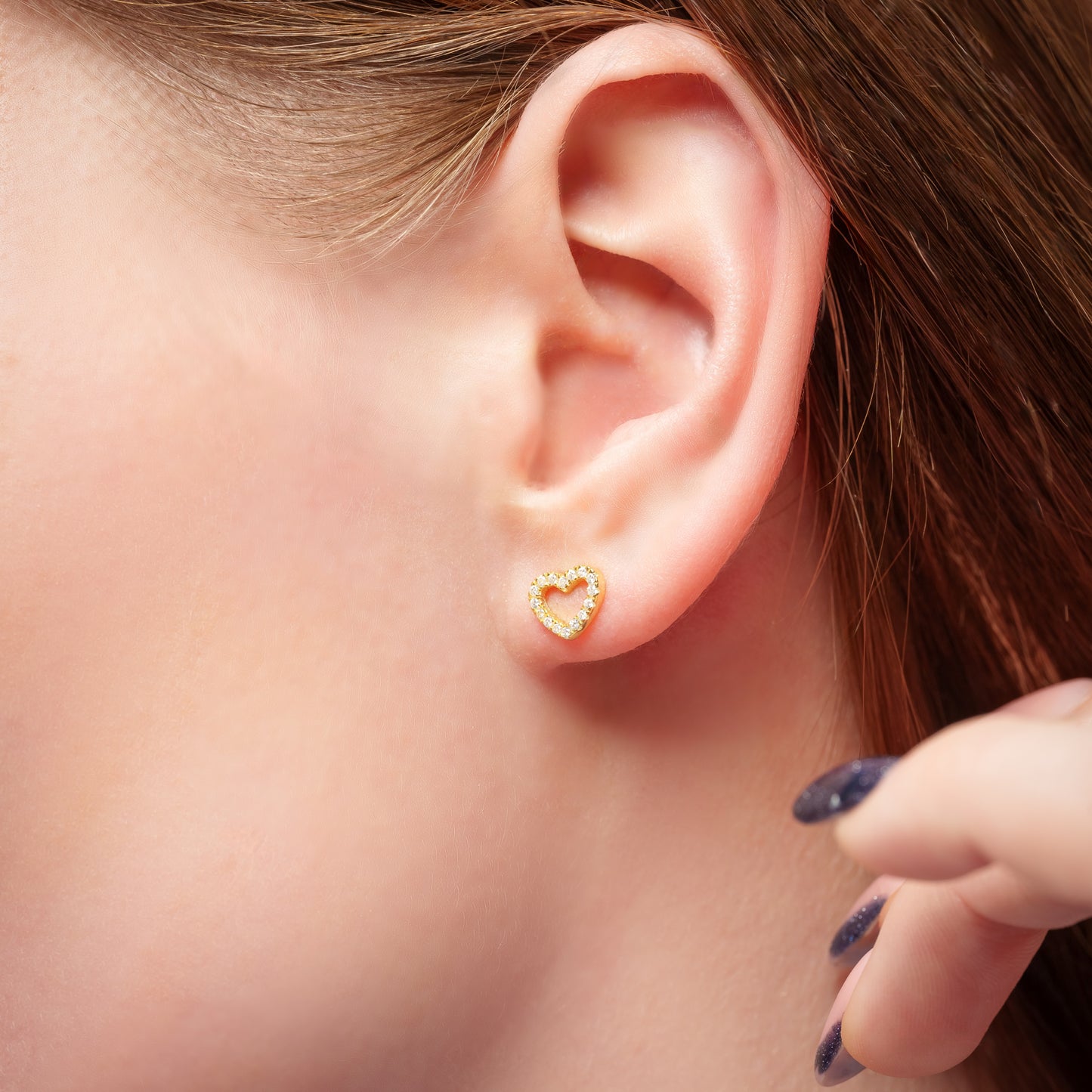 A model showing Love Heart Gold earring in her ear