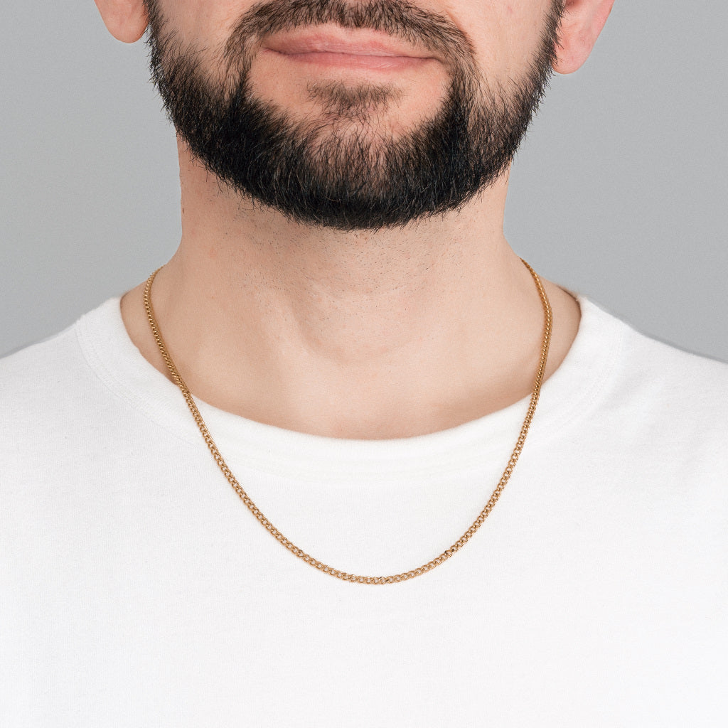 A bearded male model in white t-shirt wearing Gold Micro Cuban link chain 3mm waterproof, tarnish-free