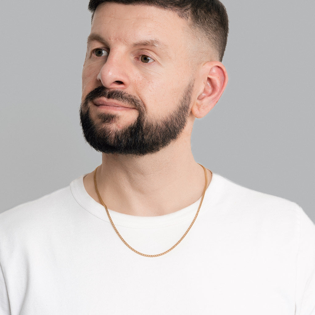 A male model in white t-shirt wearing Gold Micro Cuban link chain 3mm