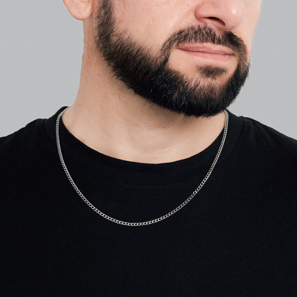 A bearded male model in black t-shirt wearing Silver Micro Cuban Link chain 3mm waterproof, non-tarnish, lifetime jewellery