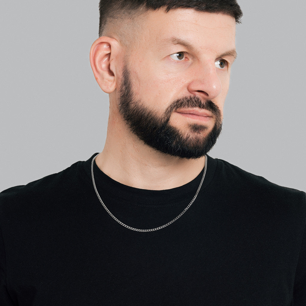 A bearded male model in black t-shirt wearing Silver Micro Cuban Link Chain 3mm, 22 inches, 55cm