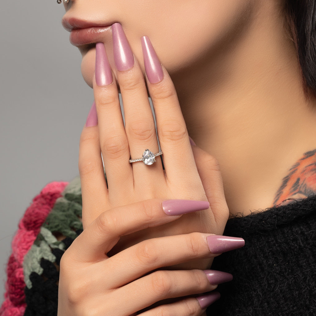 A model wearing Pear cut Cubic Zirconia 925 Sterling Silver Ring on her middle finger