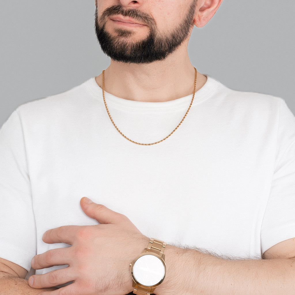 A bearded male model in white t-shirt wearing Gold Rope Chain 3mm, lifetime men's jewellery with gold watch on his hand to match the accessories