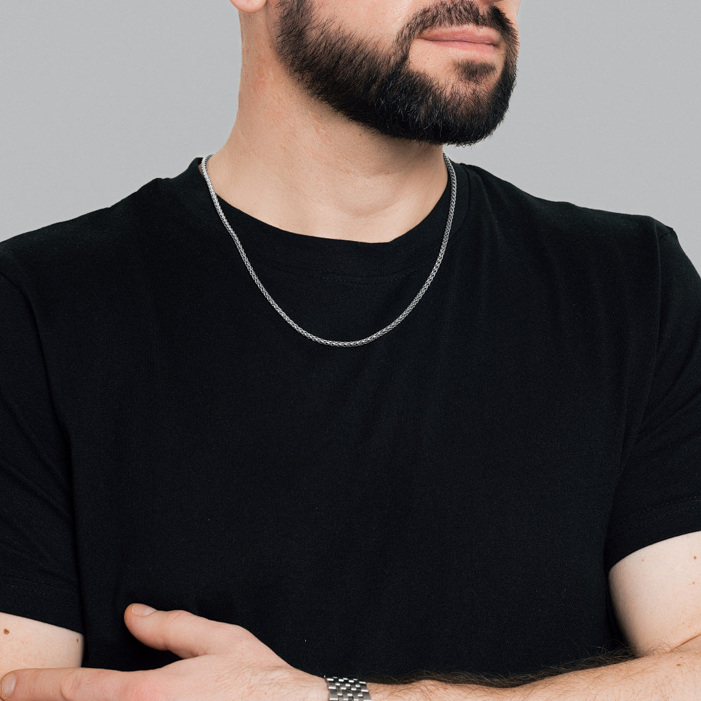 A male model in black t-shirt wearing Silver Spiga Chain 3mm and silver watch on his hand