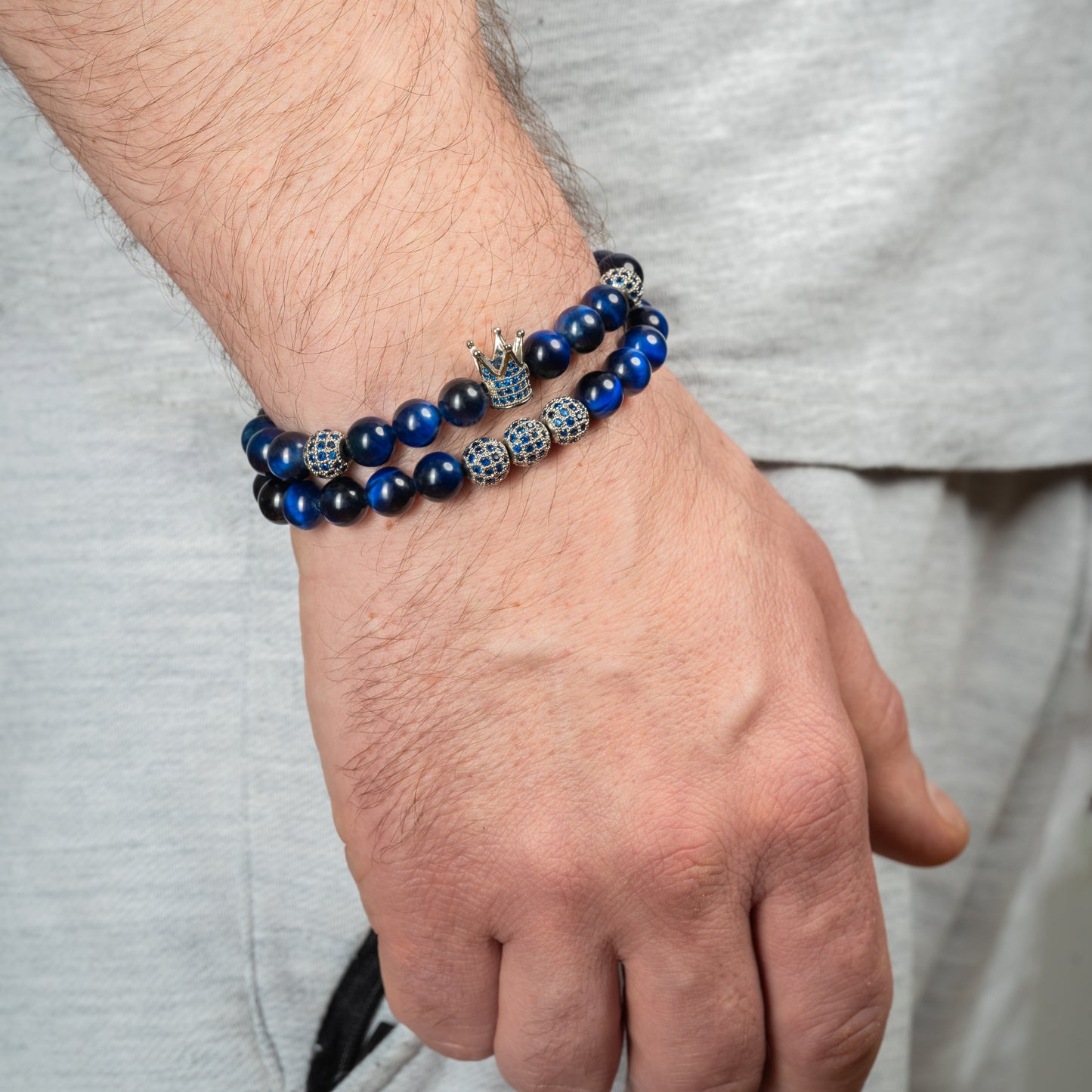 Model wearing Tiger Eye Crown Bracelet Set in blue.