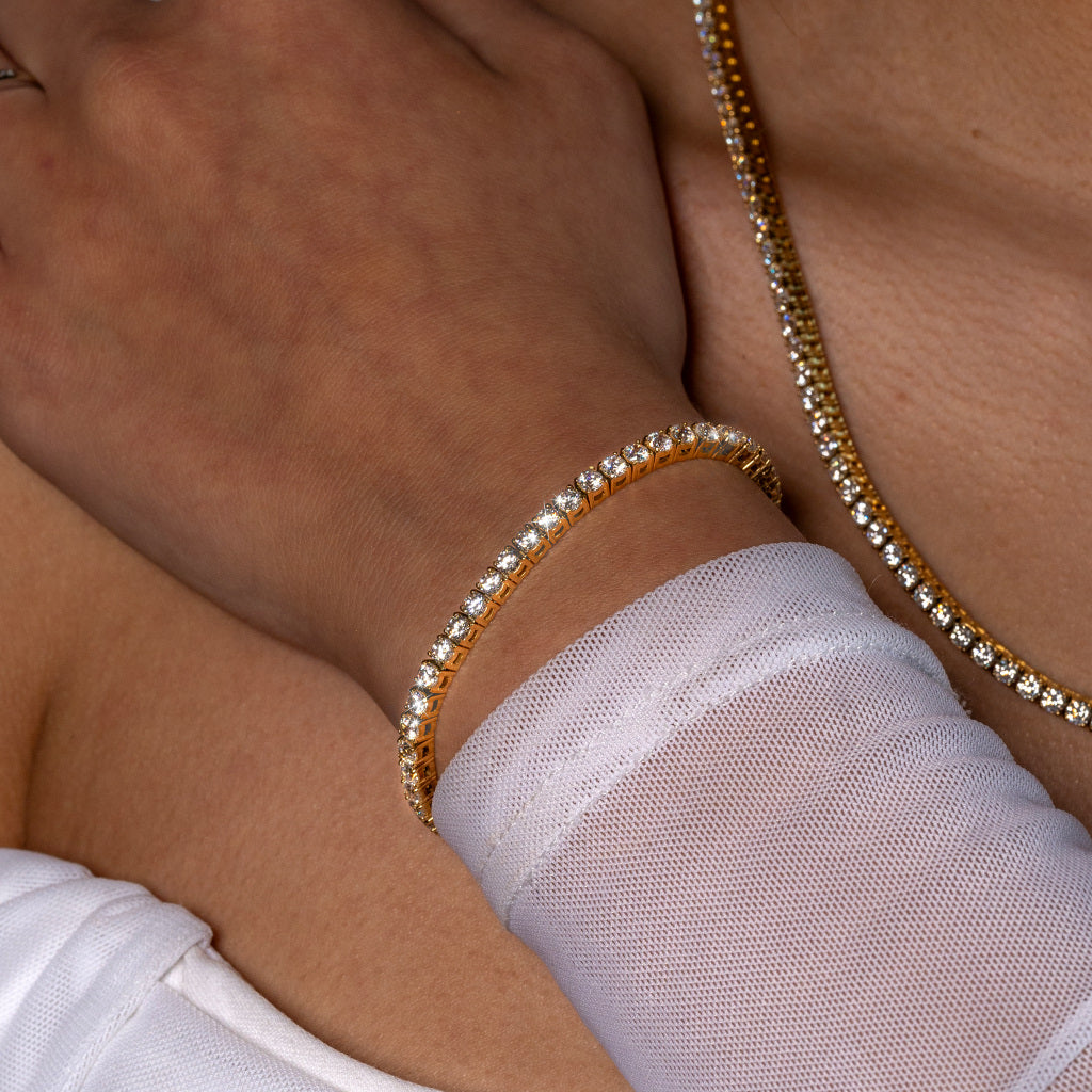 Woman wearing Cubic Zirconia 3mm Gold Tennis Bracelet paired with 3mm Gold Tennis Necklace