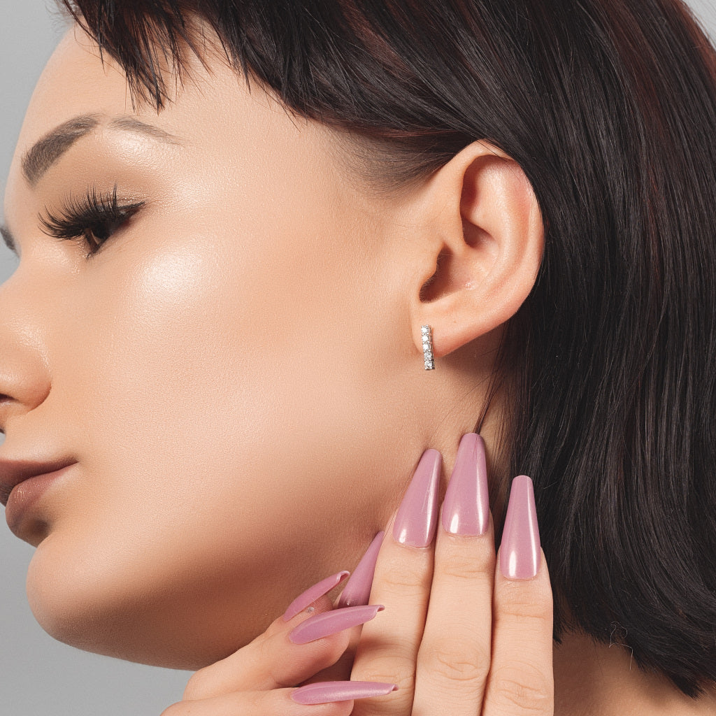 Woman wearing Five CZ Line 925 Sterling Silver stud earring in her ear