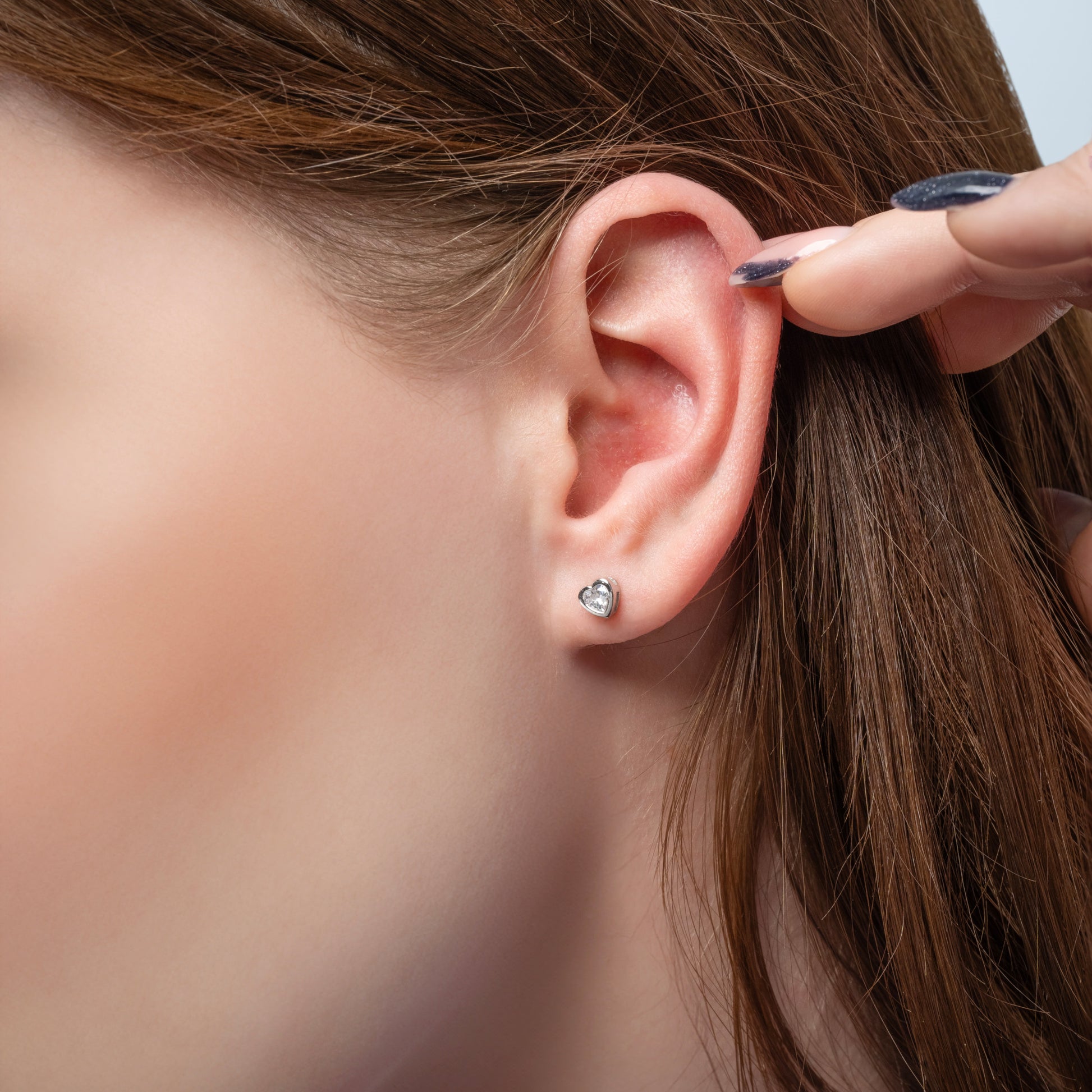 A model showing Heart Shape earring in her ear