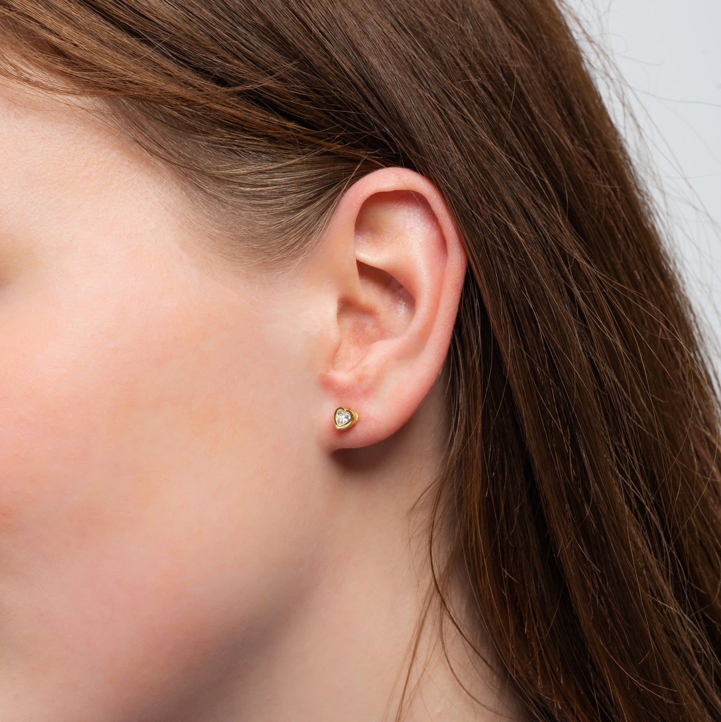 A model showing Heart Shape Gold Earring in her ear