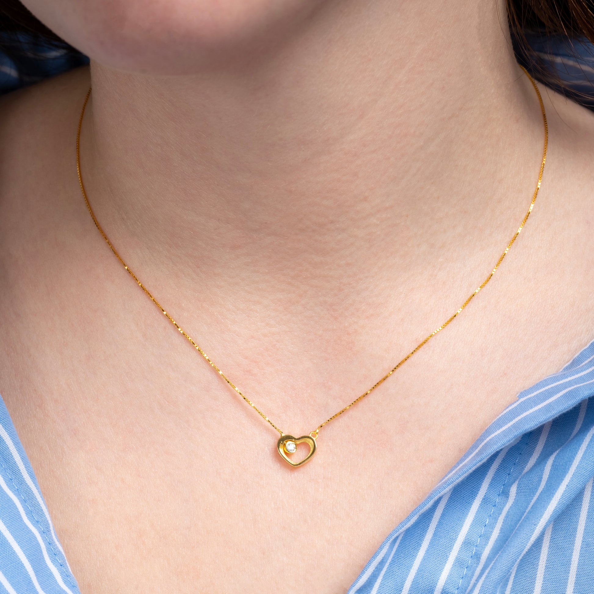 A model wearing Heart Shape Gold Necklace