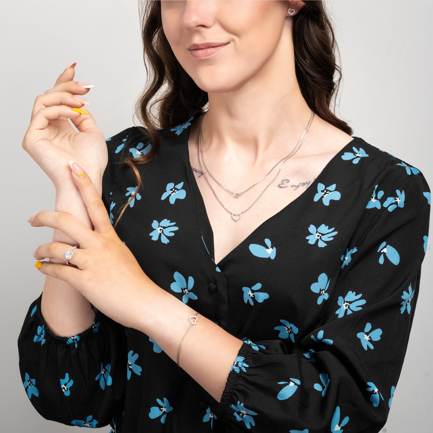 A model wearingLove Heart Earrings Necklace Silver Set with Love Heart bracelet and Mary Me Silver ring