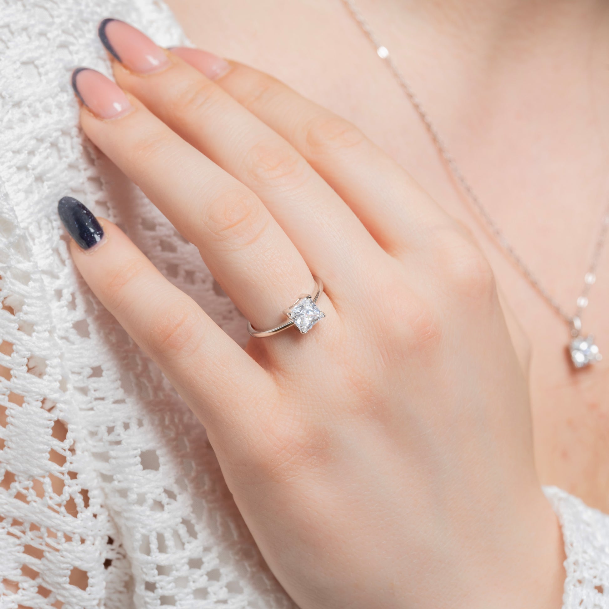 A model wearing Princess Cut Silver Ring on her ring finger