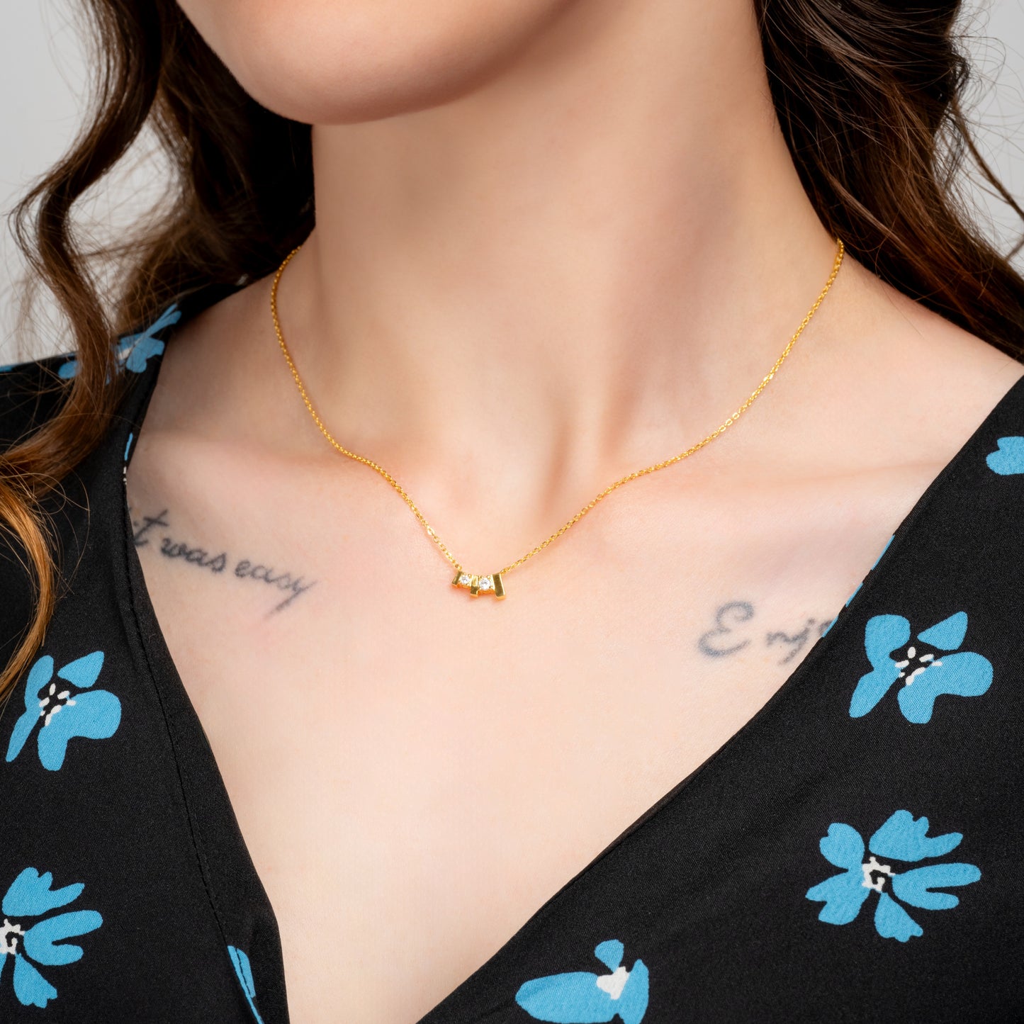 Model wearing Trilogy Gold Necklace on her neck