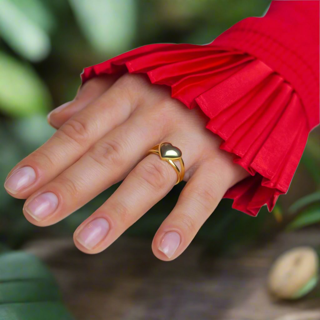 Love Heart Gold Ring on woman's finger