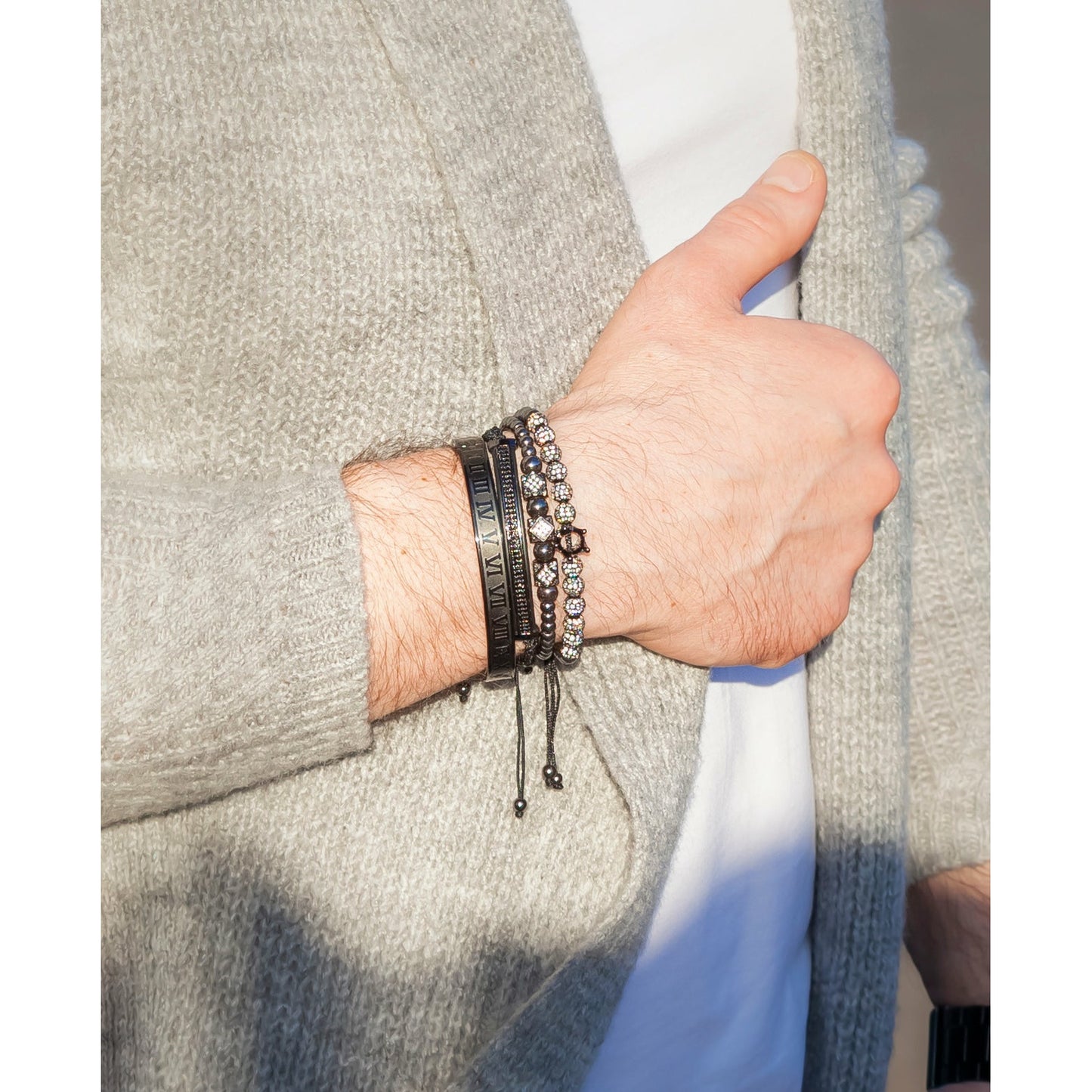 Imperial Roman King Set in Black on man's wrist wearing grey cardigan