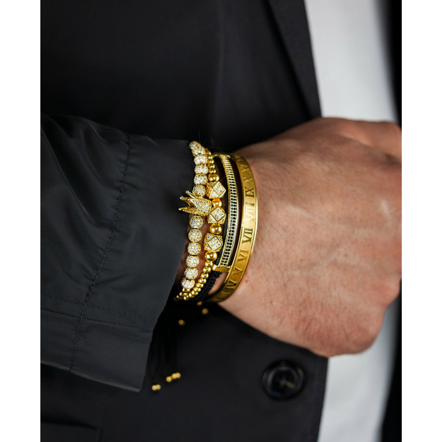 Imperial Roman King Set in Gold on man's wrist wearing black blazer
