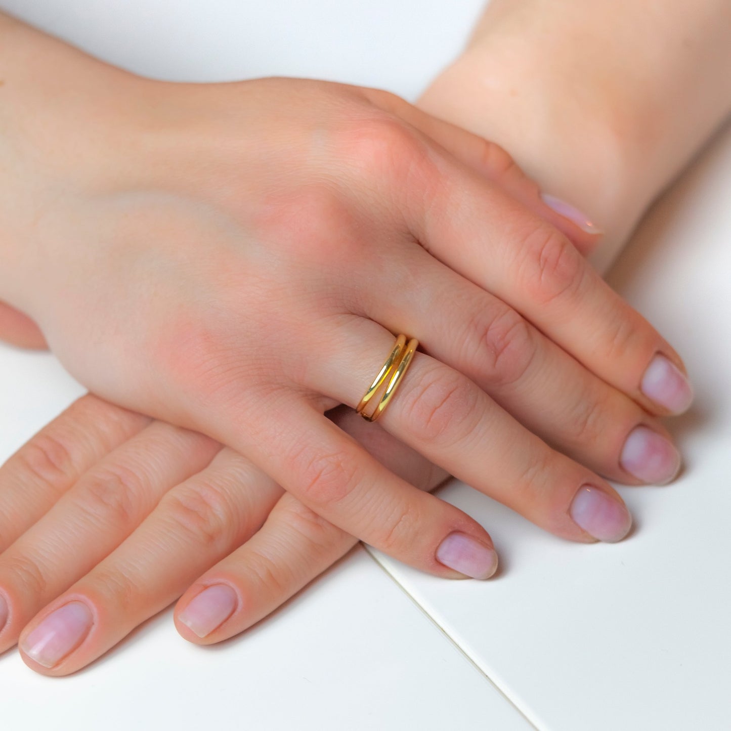 Double Gold Ring on woman's finger view
