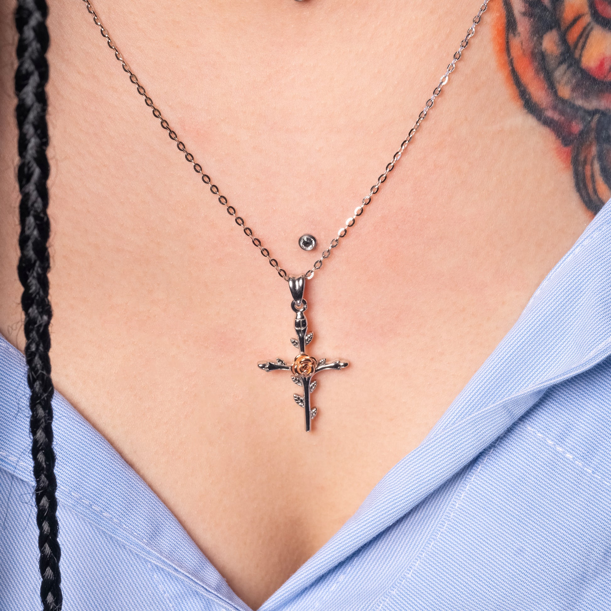 Model wearing Rose Cross Silver Pendant with Flat Cable necklace. Zoomed-in view.