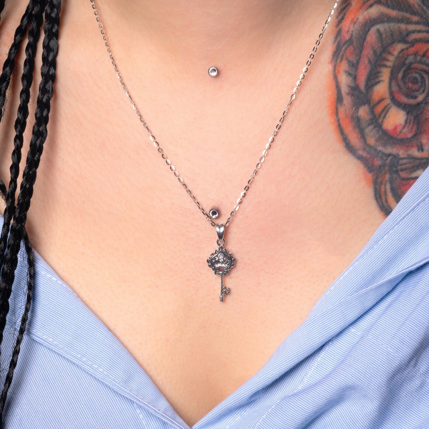 Model wearing Key Crystal Silver Pendant with Flat Cable necklace. Zoomed-in view.