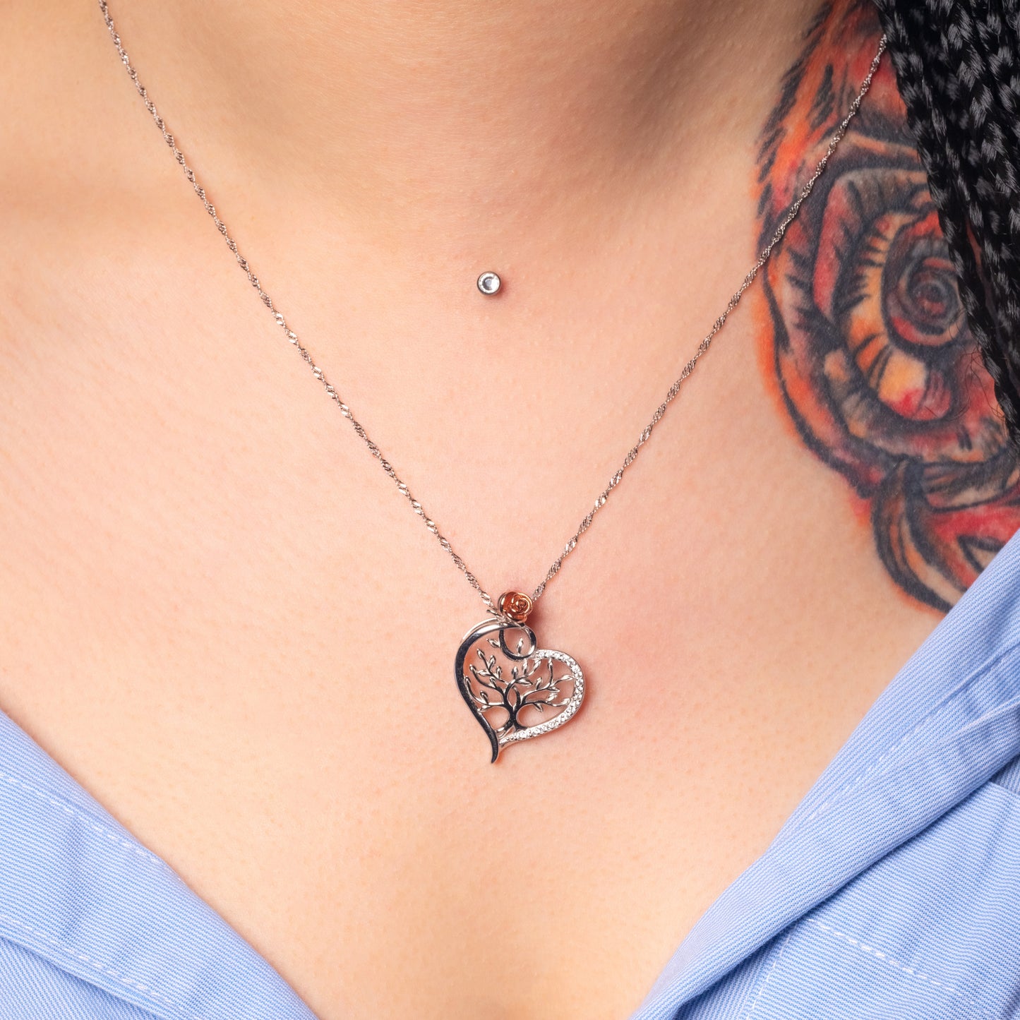 Model wearing Tree of Life Heart Silver Pendant with Water Wave necklace. Zoomed view.