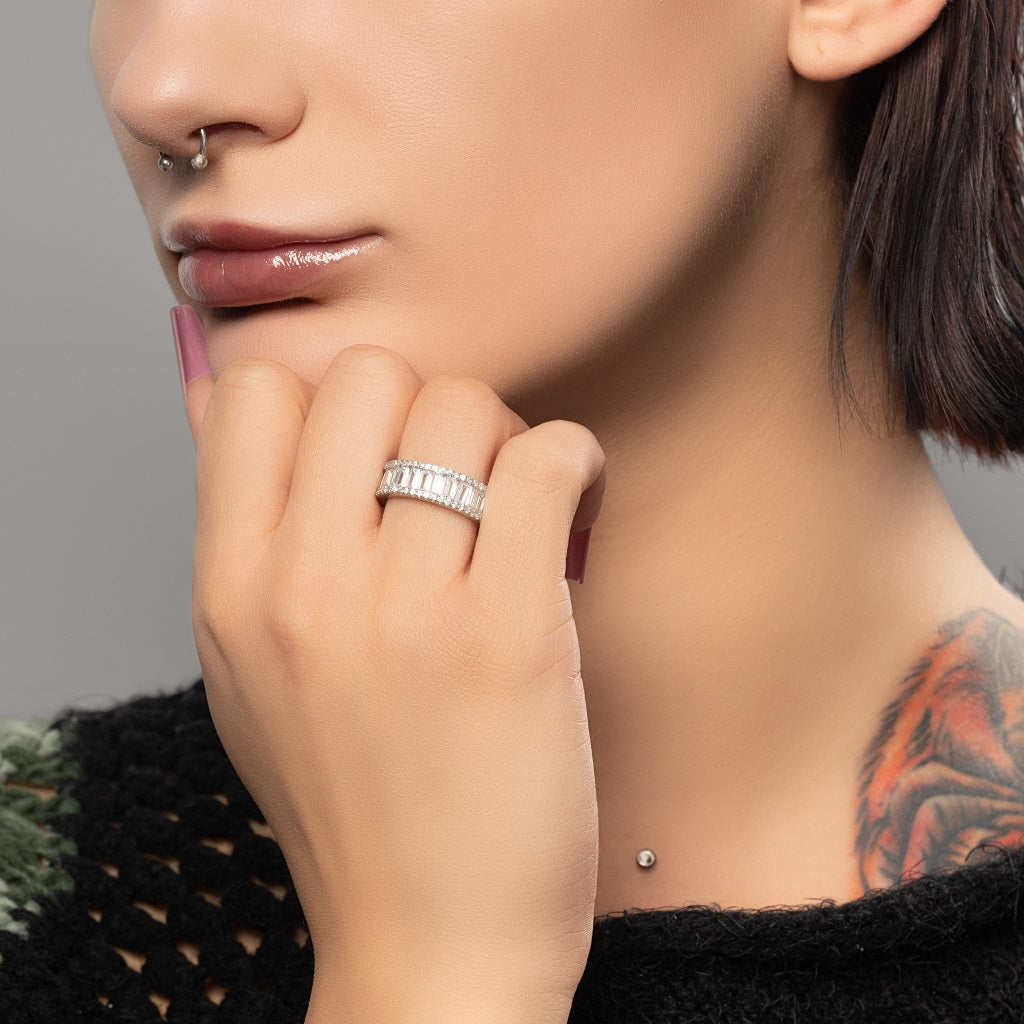 A model wearing Baguette Cut Cubic Zirconia Full Eternity 925 Sterling Silver Band Ring on her middle finger