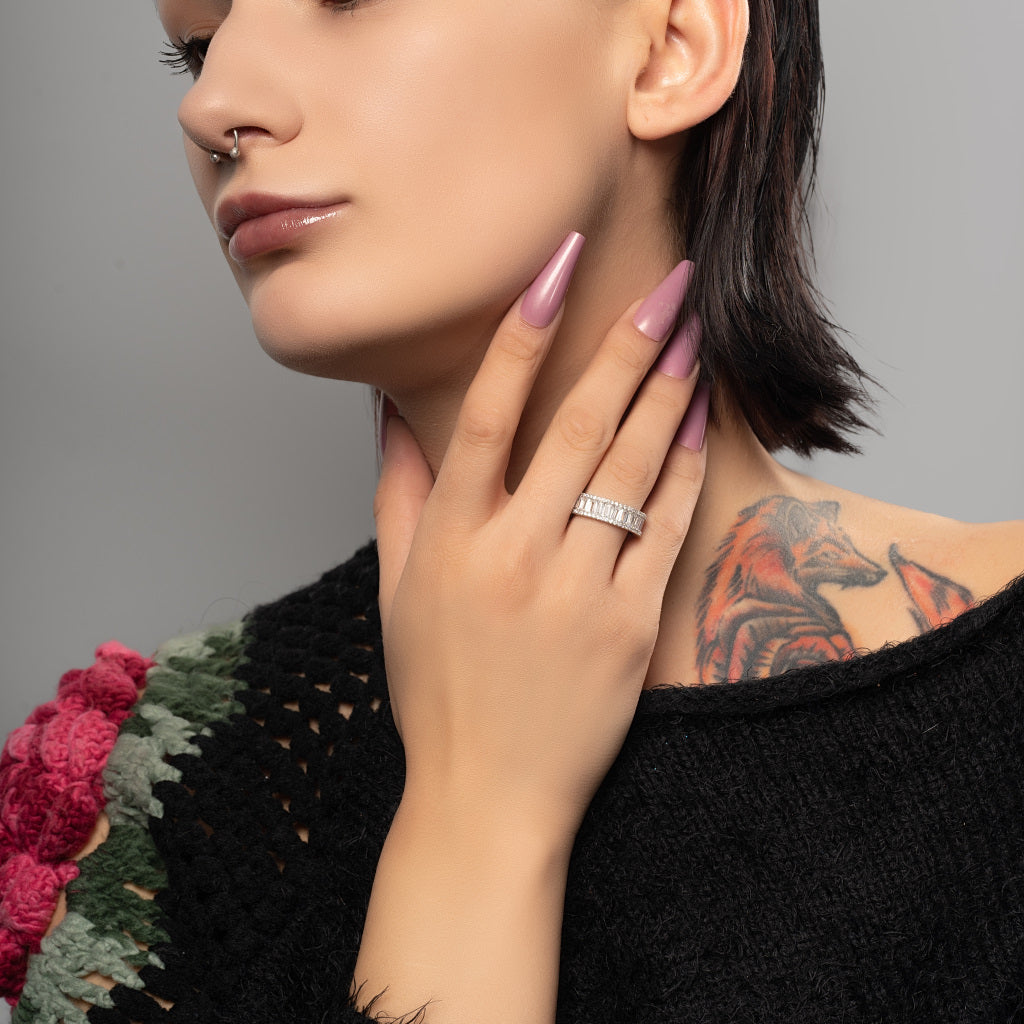 A beauty tattooed model wearing Baguette Cut Cubic Zirconia Full Eternity 925 Sterling Silver Band Ring on her middle finger