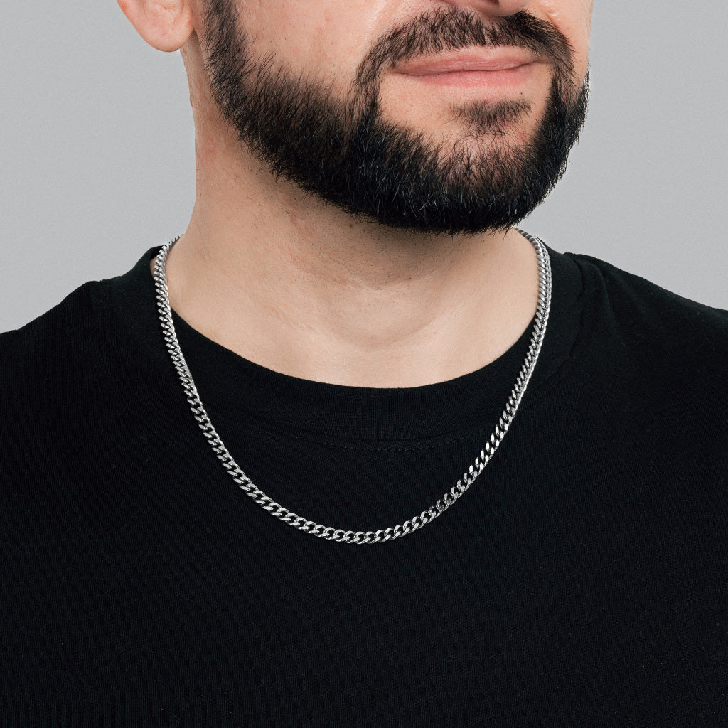 A bearded male model in black t-shirt wearing Silver Miami Cuban Chain 5 mm, statement, lifetime, stainless steel men's jewellery