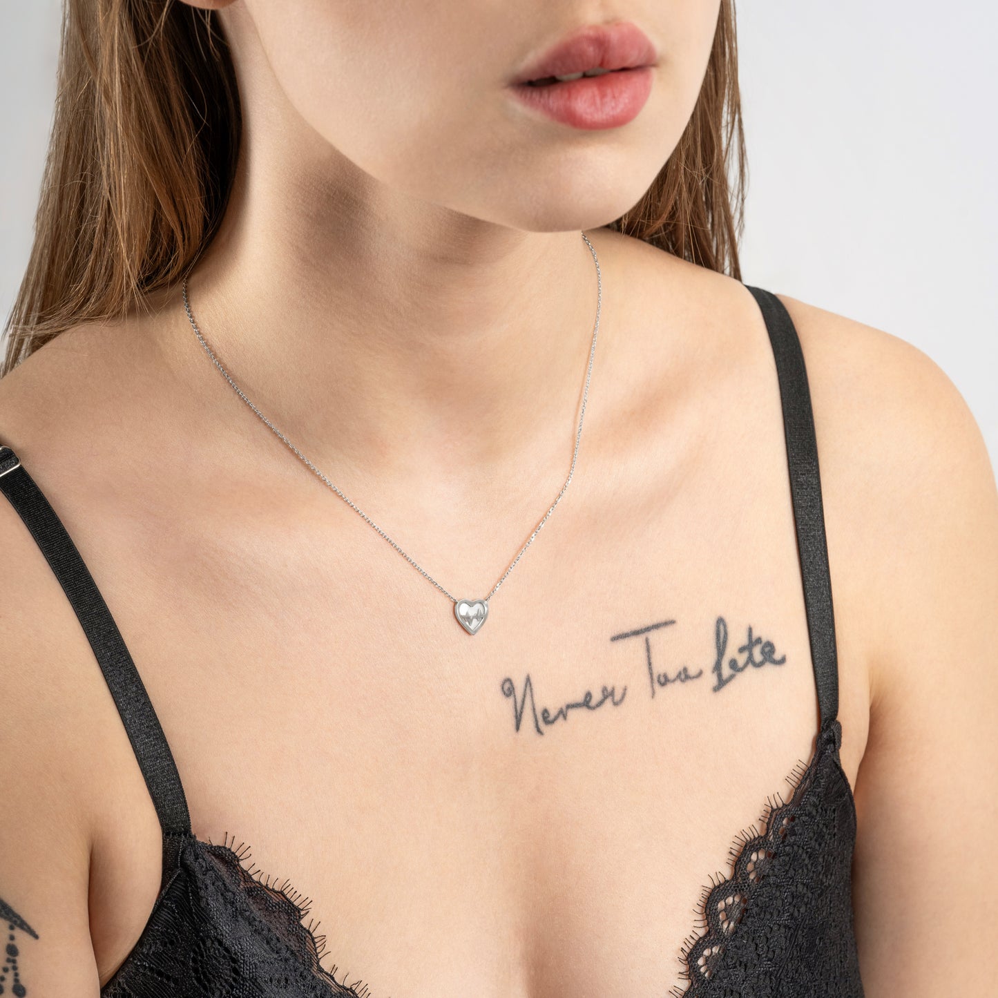 A model wearing Heartbeat Silver Necklace on her neck