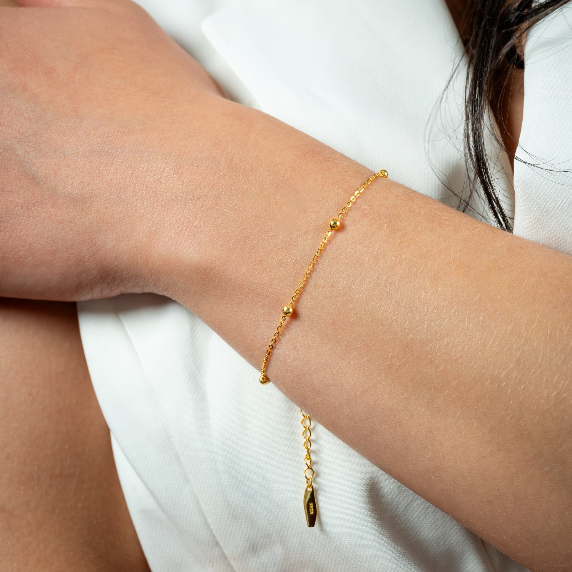A model wearing Bead Chain Gold Bracelet on her hand. Zoomed view.
