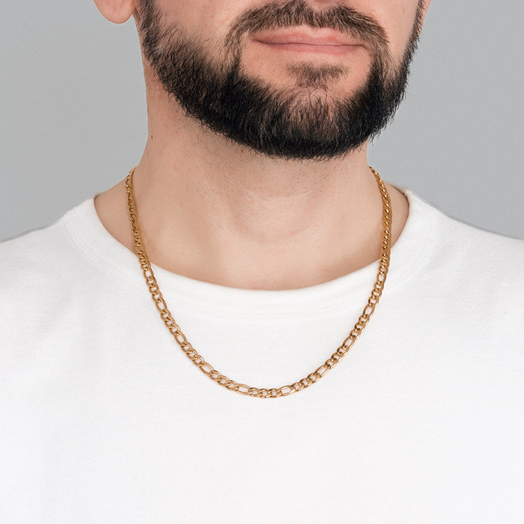 A bearded male model in white t-shirt wearing Gold Figaro Link Chain 5 mm, 22 inches, 55 cm.